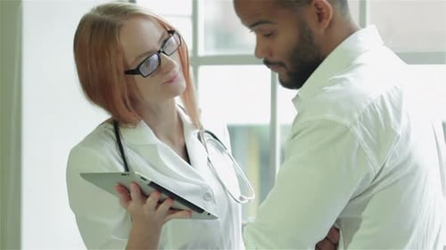 Female Doctor Discussing Information with Male Patient