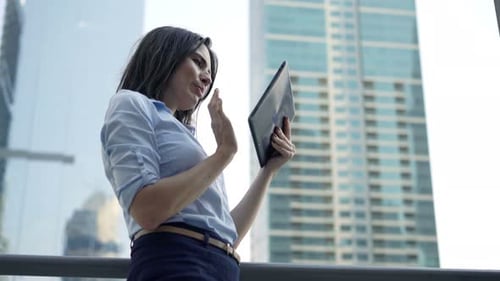 Young, Pretty Businesswoman Working with Tablet Computer Standing on Terrace 30s