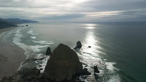 Wide Aerial Shot of Haystack Rock Beach in Coastal Town Cannon Beach Oregon