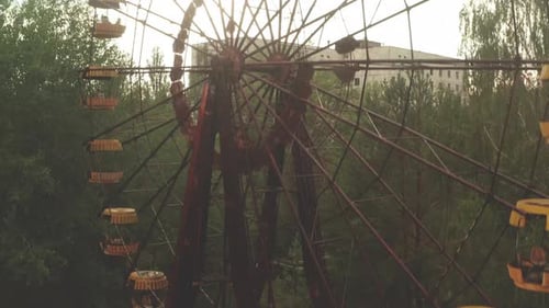 Flying at abandoned Pripyat ghost town in Chernobyl exclusion zone. The decayed Ferris wheel visible