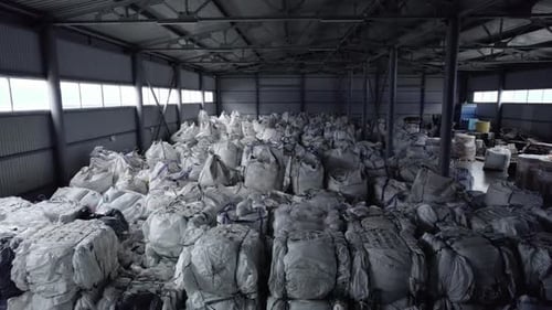 Storehouse with Heap of Packs Filled with Building Materials