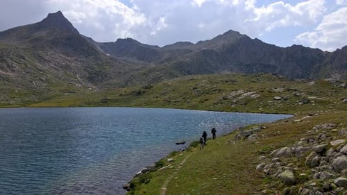 Hikers Explore Serene Mountain Lake Landscape