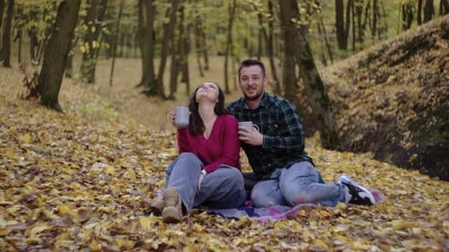 Affectionate Couple Enjoying Autumn Picnic in Forest