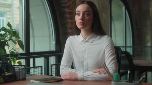 Serious Pensive Confident Caucasian Business Woman Girl Female Sitting at Table in Office Workplace