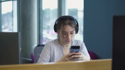 girl works at a computer in a modern office, the girl is studying