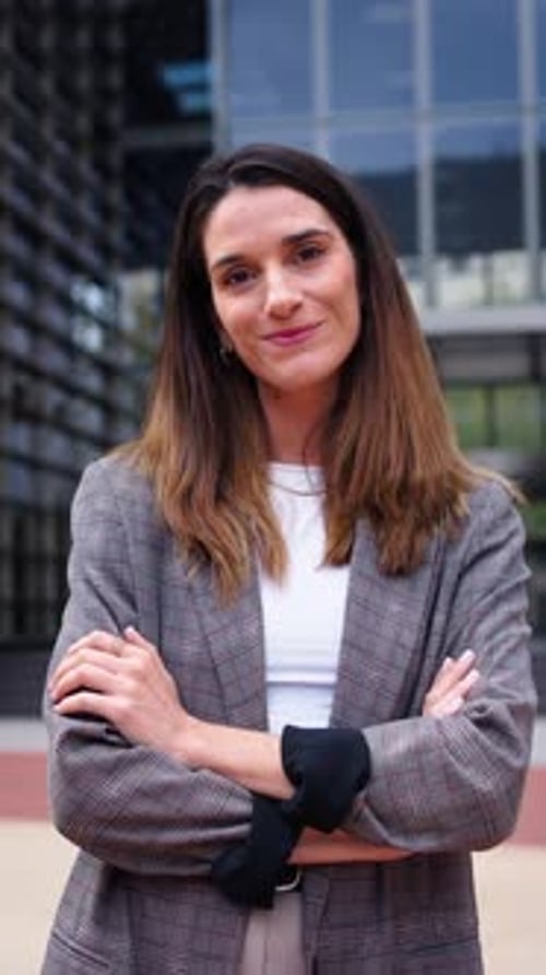 Portrait of Adult Caucasian Business Woman with Long Hair in Formal Suit Looking at the Camera
