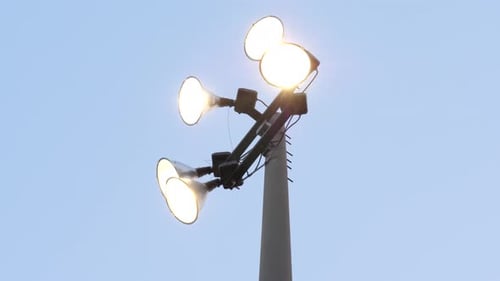 Baseball Stadium Spotlights - Low Angle Park Lights against Clear Blue Sky Background
