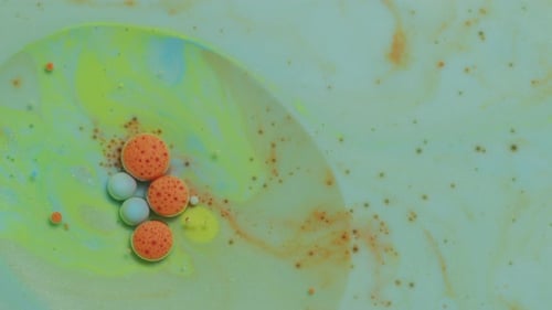 Abstract Close Up Texture of Oil with Green, Orange and Blue Paint Abstract