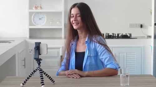 Young Woman Vlogging at Home in Kitchen