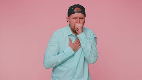Man Coughing and Holding Chest
