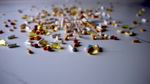 Capsules, tablets, gold and white, fallen mosaic of health, day and night