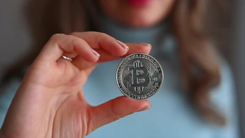 Woman holding a bitcoin crypto currency close up