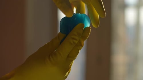 Closeup Cropped Shot of Unrecognizable Man Wearing Gloves Kneading in Hand Preparing Blue Slimy