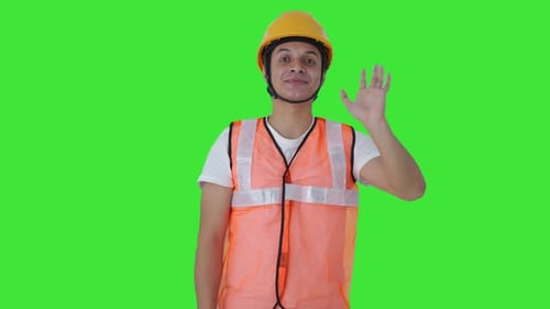 Happy Indian construction labour waving Hello Green screen
