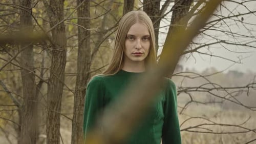 Model posing for fashion photoshoot in autumn forest