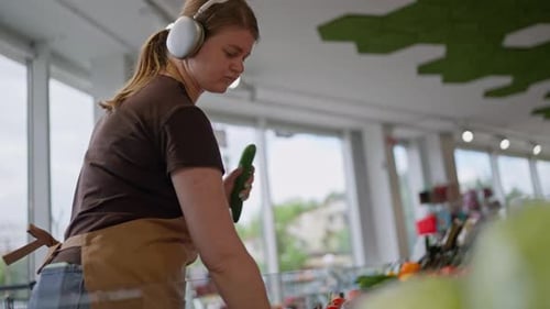 Woman Inspecting Produce in Grocery Store
