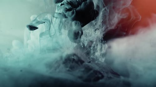 Close up of liquid in different colors exploding underwater - paint ink or smoke design