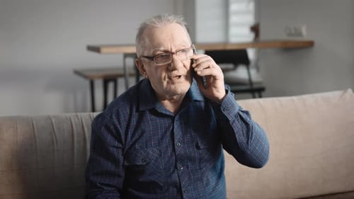 Senior Man Talking on Cell Phone at Home