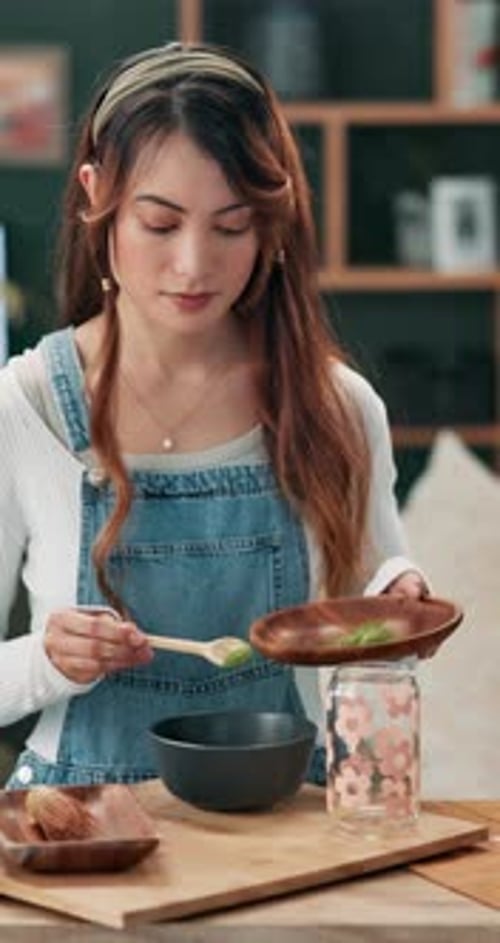 Young Woman Prepares Food in Kitchen