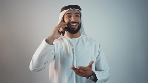 Smiling Man Talking on Cellphone in Gulf Clothing