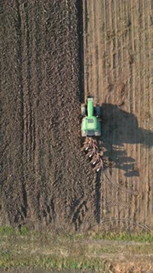 Tractor Plows Land In The Field Aerial