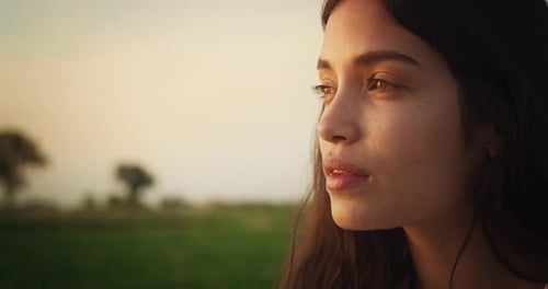 Woman Smiling Outdoors in a Rural Setting