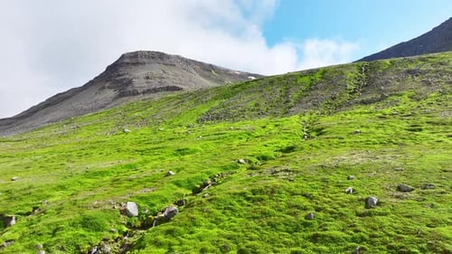 Mountains Covered With Green Moss And Grass On A Sunny Day Small River Flows Down The Slope