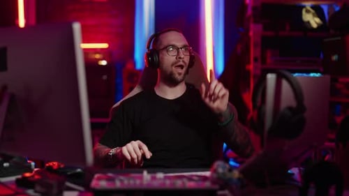 Man With Headphones Talking in Gaming Studio