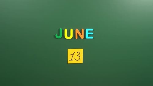 Hand sticking a sticker 13 June calendar day on school board. 13 date of June. Thirteenth day
