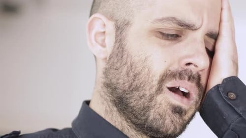 Man Suffering from Headache and Toothache Pain