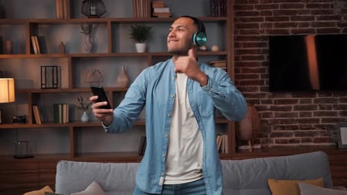 Man Listening to Music and Dancing at Home
