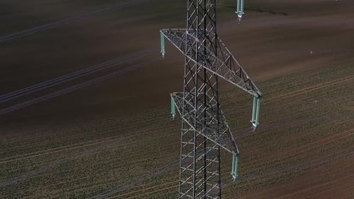 High-Voltage Transmission Tower Over Farm Field