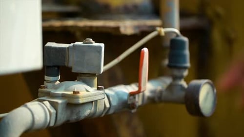Production operator close ball valve at Asphalt plant for control production process. Worker hands s