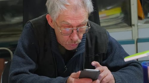 Senior Man Using Smartphone Indoors
