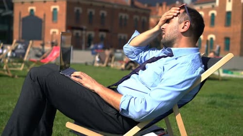 Upset Businessman Having Problems During Work on Laptop in City 30s