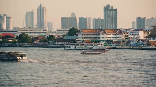 Everyday Scenes in Bangkok As Boats Traverse Chao Phraya River Cityscape of a Mix of Contemporary