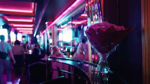 The Restaurant Features a Vibrant Interior Designed with Colorful Lights and a Beautiful Floral