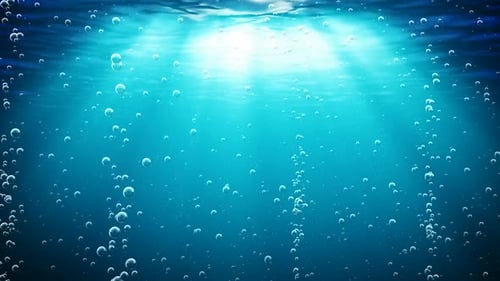 Looping Animation of Ocean Waves From Underwater with Bubbles. Light Rays Shining