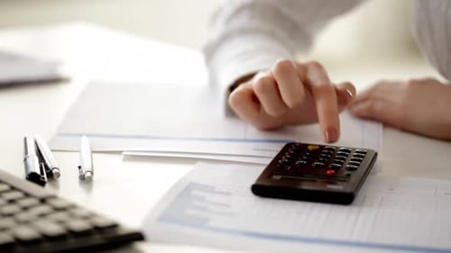 Calculator and Paperwork for Workplace Accounting