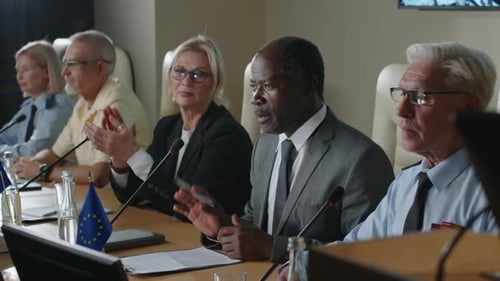 Council Members Speaking and Clapping at Meeting