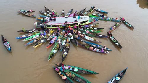 Local women selling fresh tropical fruits and vegetables on traditional Jukung boats at Lok Baintan