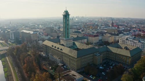 Down drone shot around ostrava city hall tower in summer