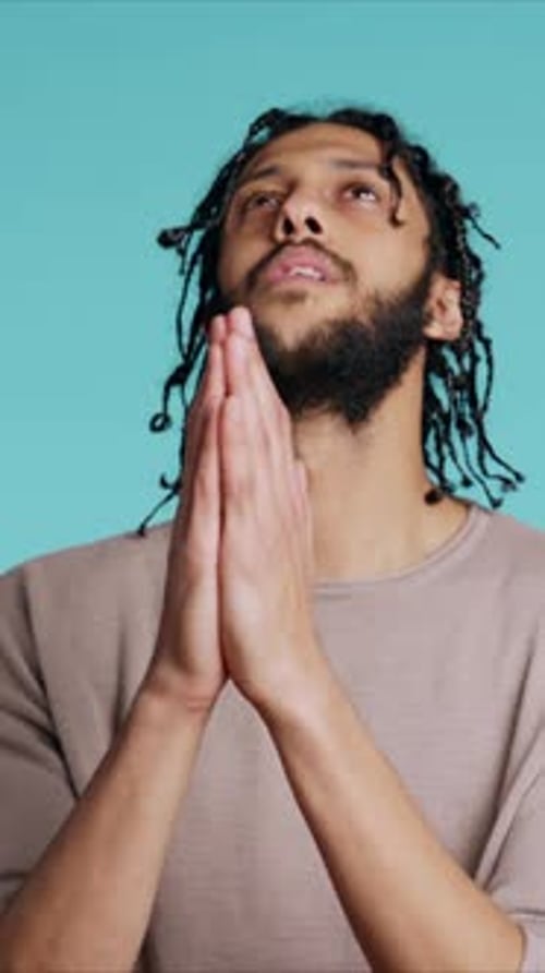 Vertical Video Pious Man Praying to His God Asking for Forgiveness Feeling Desperate Studio