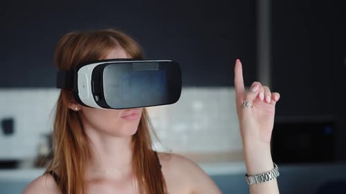 Woman Wearing VR Headset Interacting with Virtual World