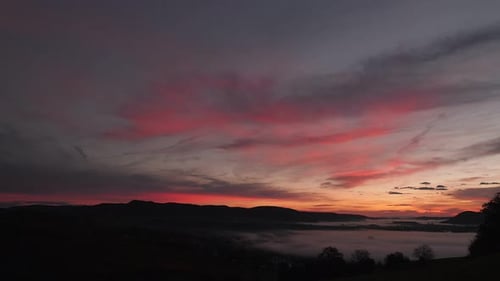 Serene Sunrise over Foggy Rural Valley