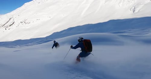 Two Professional skier skiing deep snow. Freeride skiing in Ischgl. Offpist with fresh snow on ski's