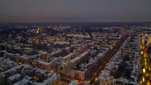 Berlin City lights, rooftops covering in snow winter at dusk. Breathtaking aerial view drone