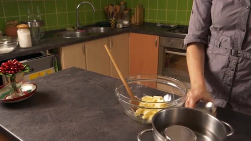 Close up shot of a young woman crushing butter and later mixing in honey from a jar. Preparing a cak
