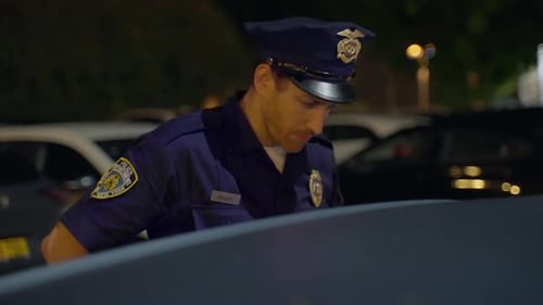 Police Officer Communicates Via Radio at Night