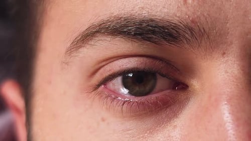 Close-up of man's eye closing.